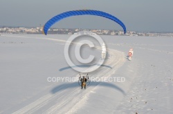Aerial view of paramotor following a road in winter in France